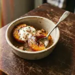 Delicious baked peaches with cinnamon and vanilla ice cream on top